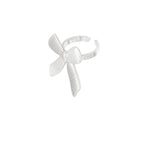 Silver bow-shaped ring on a white background