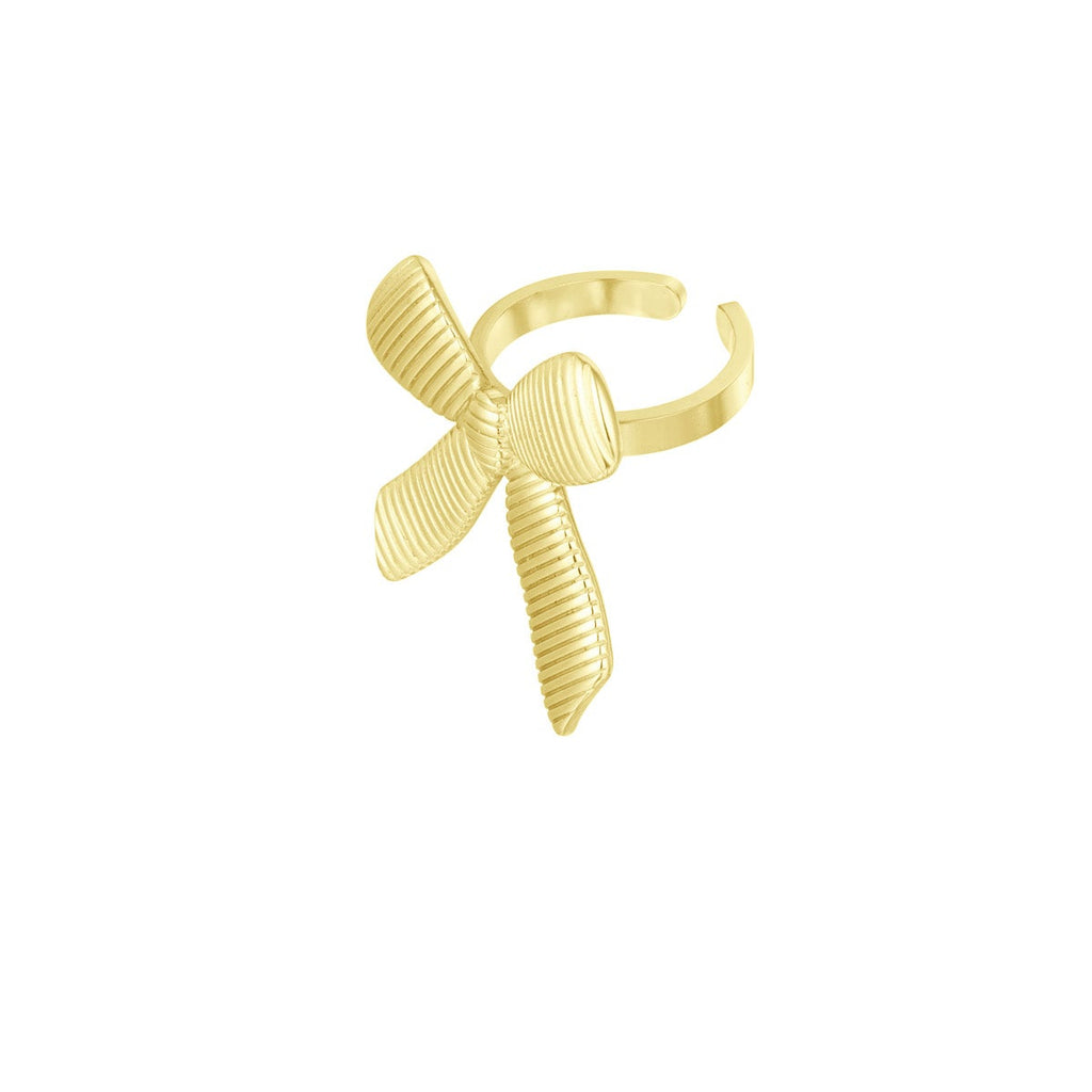 Gold bow-shaped ring on a white background