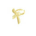 Gold bow-shaped ring on a white background