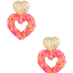 Heart-shaped beaded earrings with gold tops on a white background