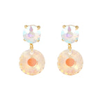 Pair of earrings with colorful circular designs on a white background