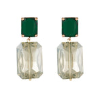 Pair of earrings with green topaz and clear rectangular stones on a white background