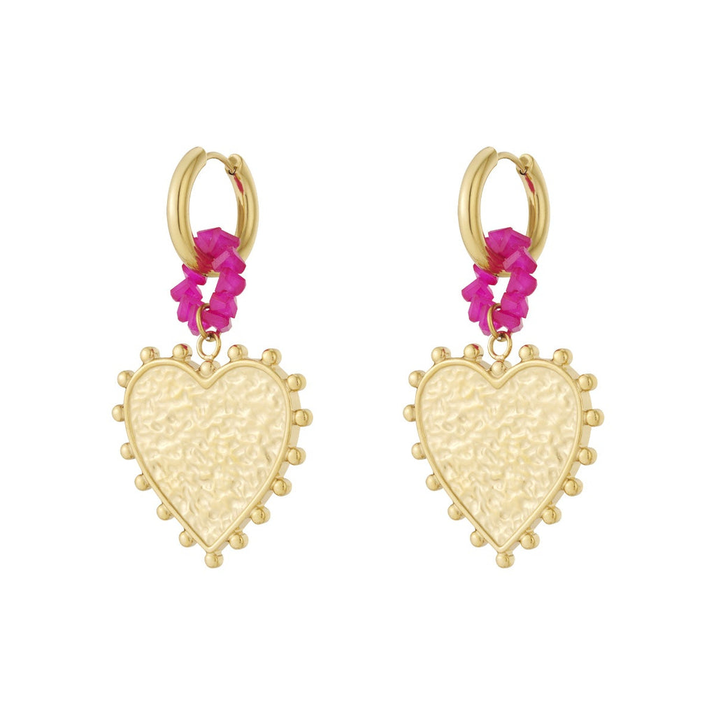 Gold heart-shaped earrings with pink floral elements on a white background