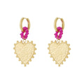 Gold heart-shaped earrings with pink floral elements on a white background