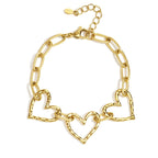 Gold chain bracelet with heart-shaped links on a white background