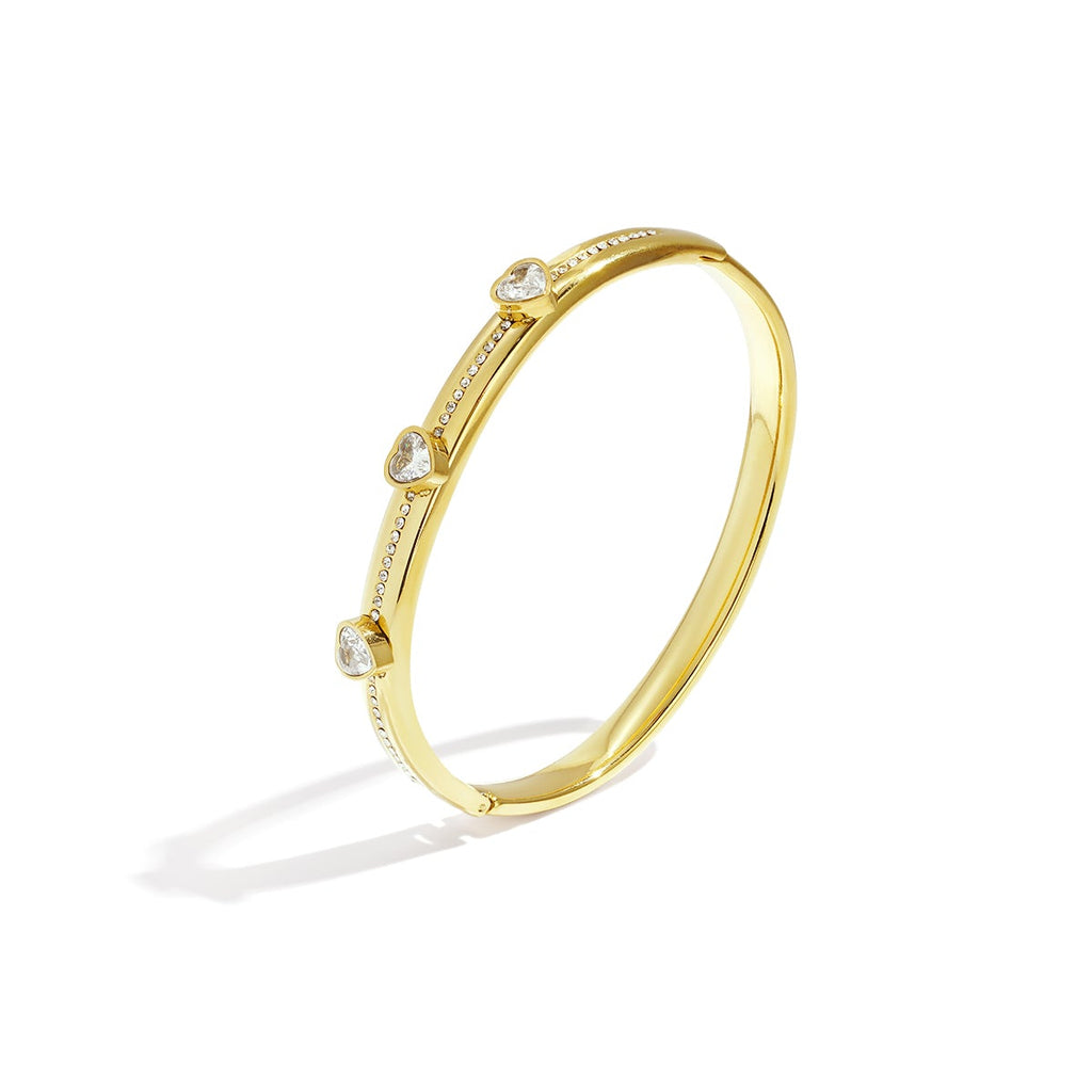 Gold bracelet with small diamonds on a white background