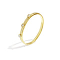 Gold bracelet with small diamonds on a white background